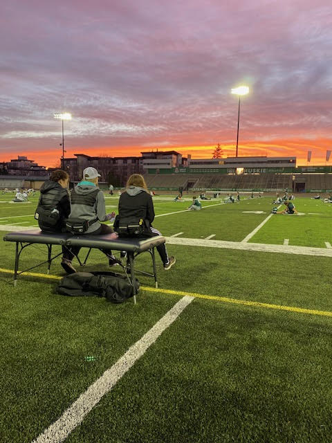 Trainers at the USask Huskies football field watching practice